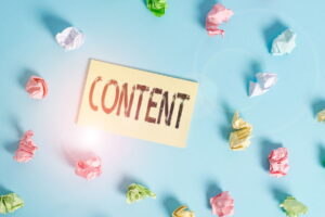 'Content' written on a yellow post it note surrounded by scrunched up pieces of paper